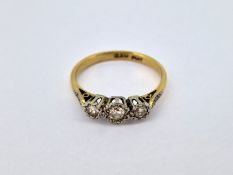A three stone set diamond ring, set in 18ct yellow gold, size O/P, approx 2.8g.
