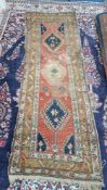 A patterned runner rug, approx 90cm x 280cm.
