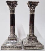 A pair of Edward VII silver candlesticks, in the form of corinthian columns, hallmarked Sheffield