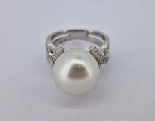 An impressive diamond and pearl ring set in 18ct white gold, approx diameter of pearl 12mm,