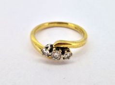 A three stone diamond twist ring, set in 18ct yellow gold, size P.