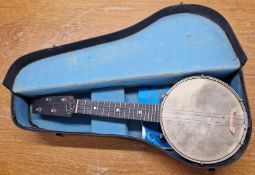 A banjo ukulele / banjolele, with metal backplate, length approx 56cm, cased.