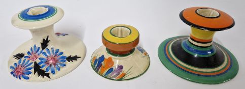 Three Clarice Cliff candlesticks, to include 'Crocus' and 'Marguerite' pattern, and another abstract