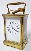 A gilt carriage clock, roman enamel dial, with key, height approx 18cm.