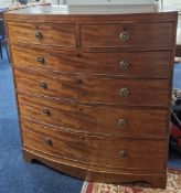 An early 19th century chest of drawers, bow front with two half width over four full drawers, on