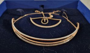 A Swarovski rose gold necklace and a Michael Kors bracelet.