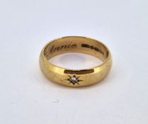 A 9ct gold band ring set with a single small stone, approx 4.1g.