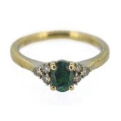 A diamond and emerald seven stone cluster ring, set in 18ct white gold, emerald 0.58ct, set with