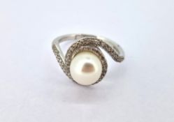 A diamond and pearl swirl ring, set in 18ct white gold, size P, approx 4.9g.