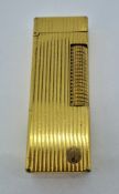 A gold plated Dunhill lighter.