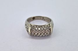 A seven row diamond ring set with further diamonds to the shoulders, set in 18ct white gold, marked