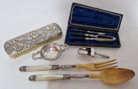 A collection of white metal, probably silver, unmarked, items, to include tea strainer, brush, and