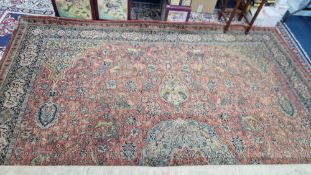 A patterned rug, approx 310cm x 350cm, decorated in tigers, lion, etc hunting.