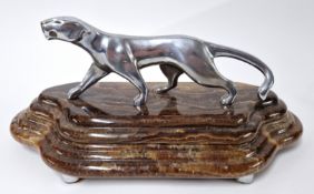 After Michel Decoux (1837-1924), an art deco bronze style sculpture of a silvered panther on a brown