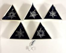 Swarovski Crystal Glass, a collection of five Christmas stars including 2001, 2000, 1998, 1997,