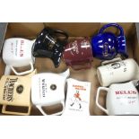 A collection of Wade water jugs to include Grants, Johnny Walker, Bell's, Teachers, Highland