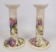 Moorcroft, Magnolia on Cream Ground Candlesticks. Height: 20cm (2)
