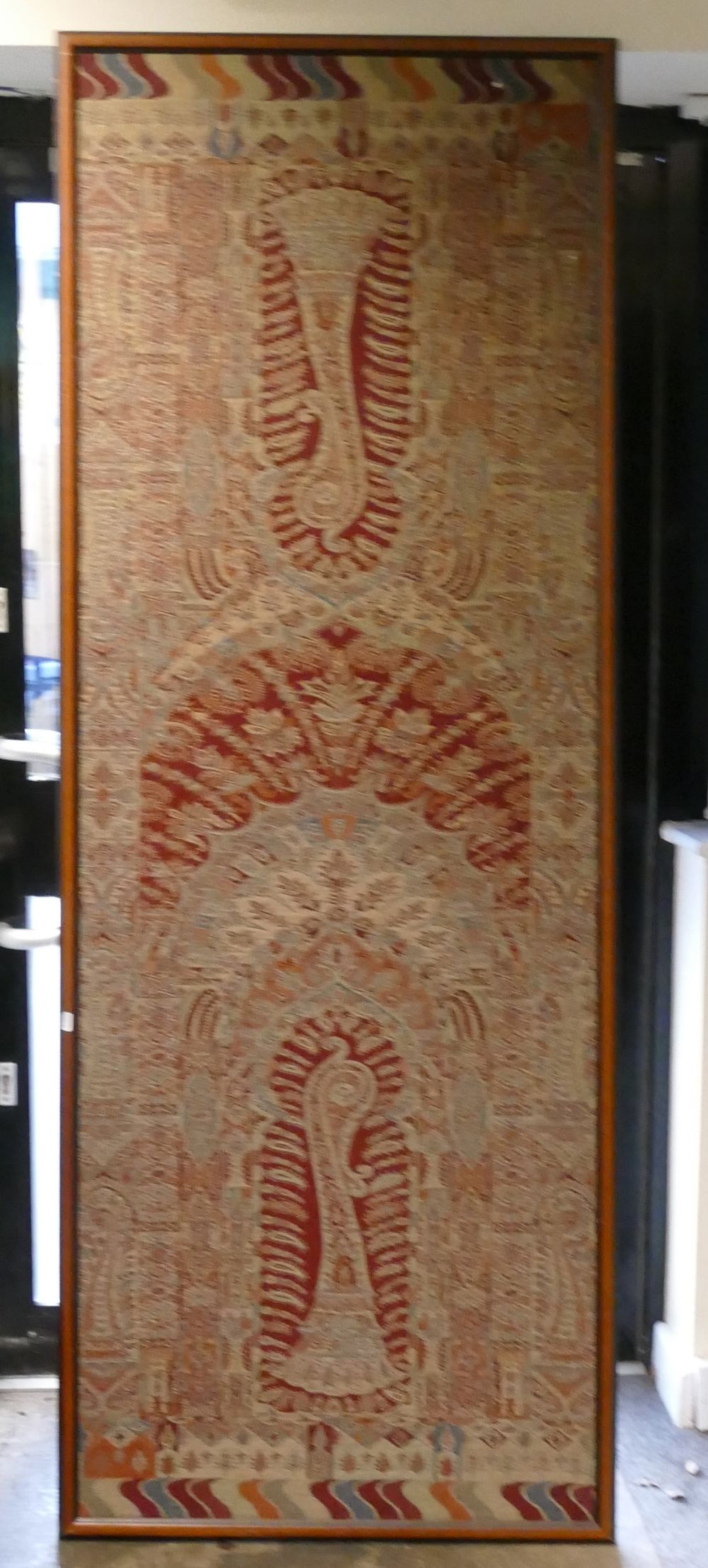 A Large Framed Paisley Panel in Red, Blue and Cream. Height: 208cm Width: 78cm