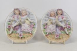 Pair Of Bisque Oval Wall Plaques Depicting Raised Detail Of A Boy And Girl Gardening (2)