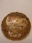 A Satsuma shallow bowl traditionally decorated with Japanese scenes and heavy gilt, 30cm in