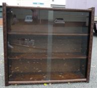 Wooden display cabinet with sliding glass doors. (H: 78cm L: 87cm W: 24cm)