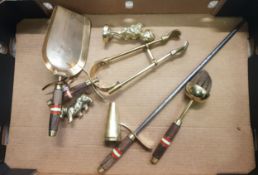 A brass fireside companion set with inlaid turned hardwood handles together with small brass figures