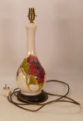 Moorcroft, Hibiscus pattern on cream ground table lamp on wooden plinth. (H: 43cm)