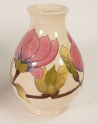 Moorcroft Pottery, Hibiscus on cream ground vase. Height: 19cm