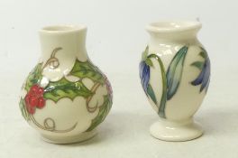 Moorcroft, Two miniature vases in Bluebell and Holly designs. Height: 6cm (2)