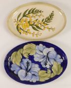 Moorcroft Pottery, Two oval trays in the Blue Hibiscus and Wattle patterns. Length: 23cm (2)