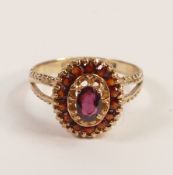 9ct gold ring, set with red centre and surrounded stones, size Q, 3.2g.