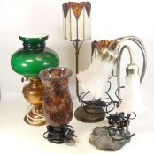 A selection of four table lamps to include a tiffany style lamp, electric oil lamp style and a metal