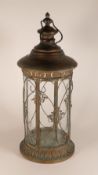 Ornate metal and glass round lantern, with hinged door and carrying handle, h.57 x d.25cm.