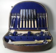 Stainless Chrome Plated 36 piece cutlery set displayed in a wooden case with feet and a blue