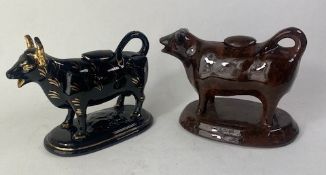 Two Staffordshire Pottery Cow Creamers both with original lids 11.5cm high