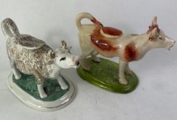 Two Staffordshire Pottery style Cow Creamers both with original lids 11.5cm high (ear chipped to