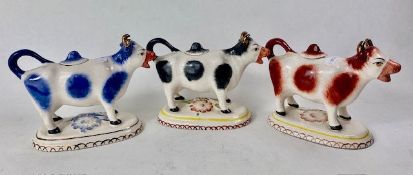 Three Staffordshire marked Pottery Cow Creamers all with original lids 11.5cm high (lid chipped to