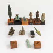 A collection of Egyptian Museum miniature REPLICA Artifacts mounted on wooden plinths, one has a