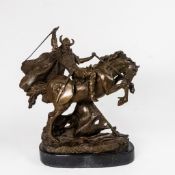 A bronze sculpture depicting a Viking warrior on horseback, mounted on a black marble base,