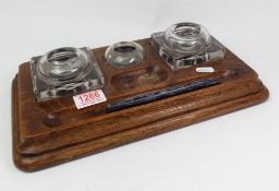 Early 20th-century oak desk stand, with glass ink wells, 36cm in length.