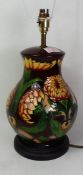 Moorcroft Dahlia pattern table lamp, designed by Philip Gibson, raised on a hardwood base, height to