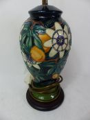 Moorcroft Passion Flower pattern table lamp, overall height to top of electrical fitting 38cm.