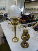 Brass oil lamp of fluted column form with flue and etched glass shade, together with a brass oil