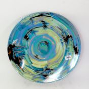 A Poole Pottery charger, abstract design and finished in a lustre glaze, diameter 40cm.