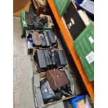 Four small trays of binoculars, most with cases