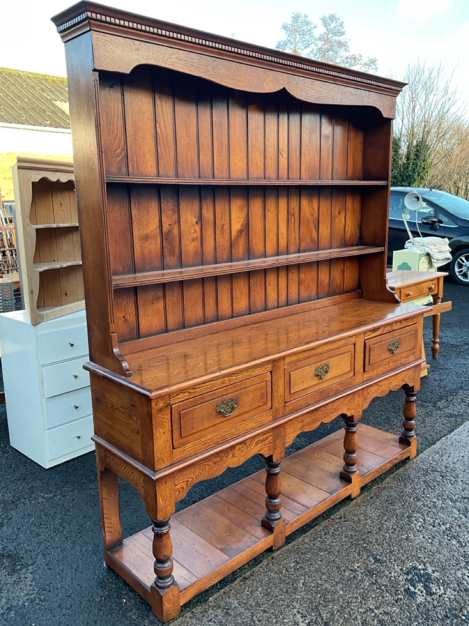 A Georgian style oak dresser with dentil cornice and shaped apron above open shelves with tongue & - Image 3 of 3