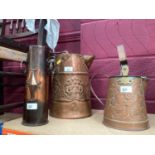 Arts & Crafts copper ewer together with another similar and a Trench Art shell case vase with ring h