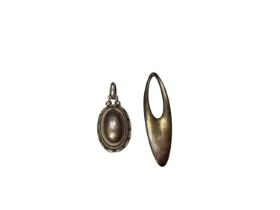 Two Georg Jensen Danish silver pendants to include an oval cabochon, no. 2001 and abstract oval, no.