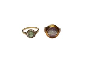 Two gold dress rings to include a green cabochon and rose cut diamond cluster ring and an amethyst s
