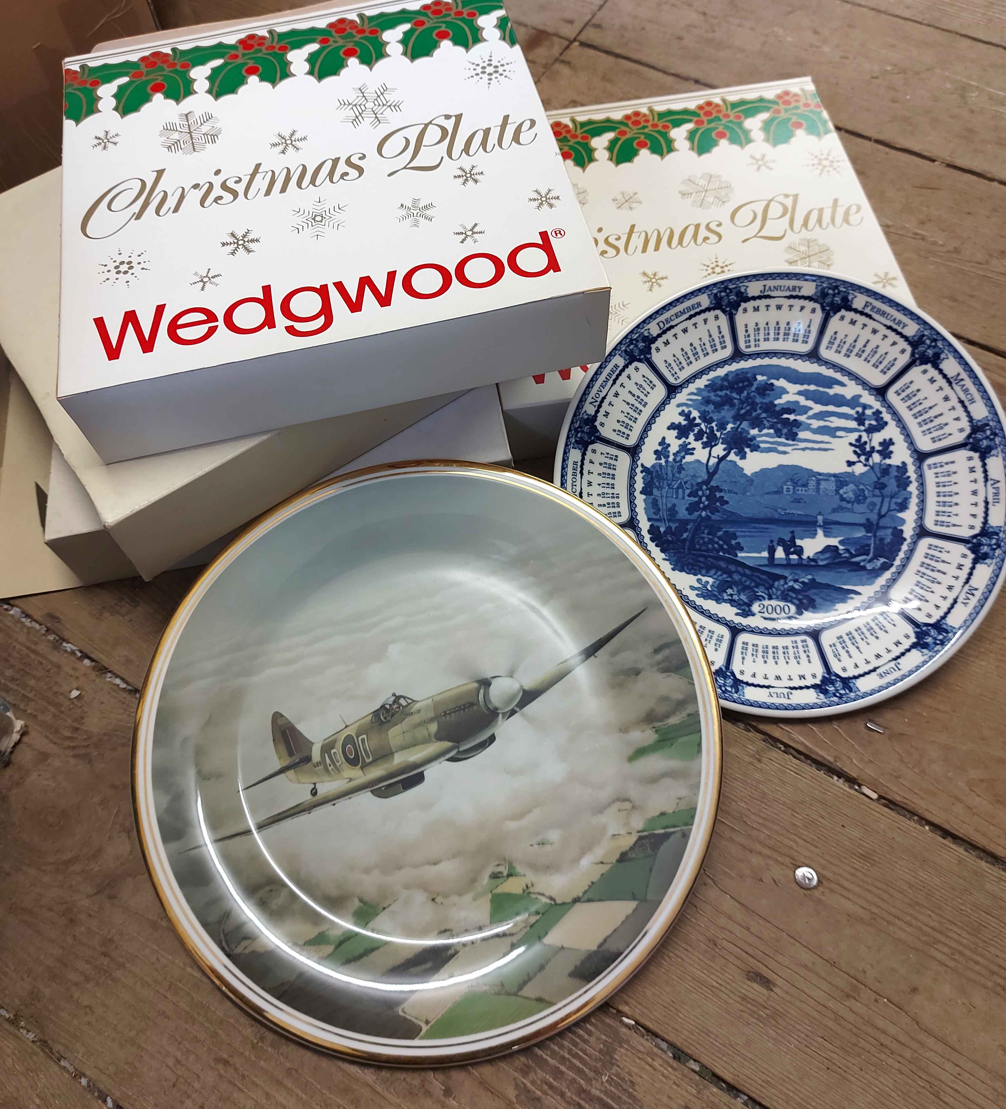 A box containing a quantity of boxed collector's plates